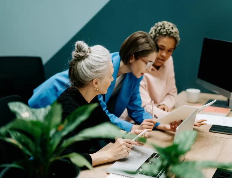 Team collaborating on project at desk.